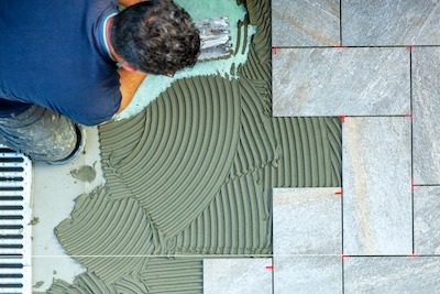 spreading-with-trowel-floor-glue-view-from-above-2024-01-31-21-37-09-utc