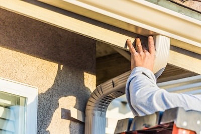 worker-attaching-aluminum-rain-gutter-and-down-spo-2023-11-27-05-10-24-utc